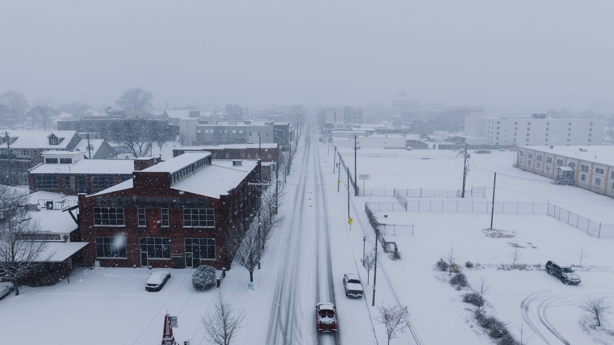 Aerial view of a city blanketed in snow, showcasing winter urban architecture.