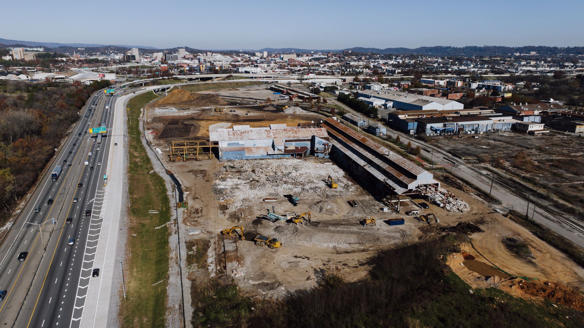 Aerial view of a construction site in Chattanooga, Tennessee with city skyline.